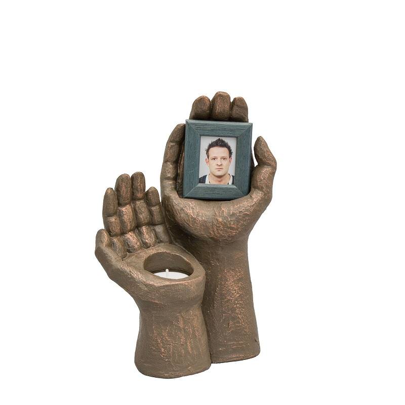 Ceramic statue hand holding urn with photo frame